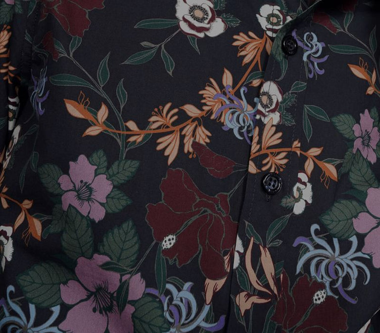 Close up of purple, green, orange, and red toned floral print on button up