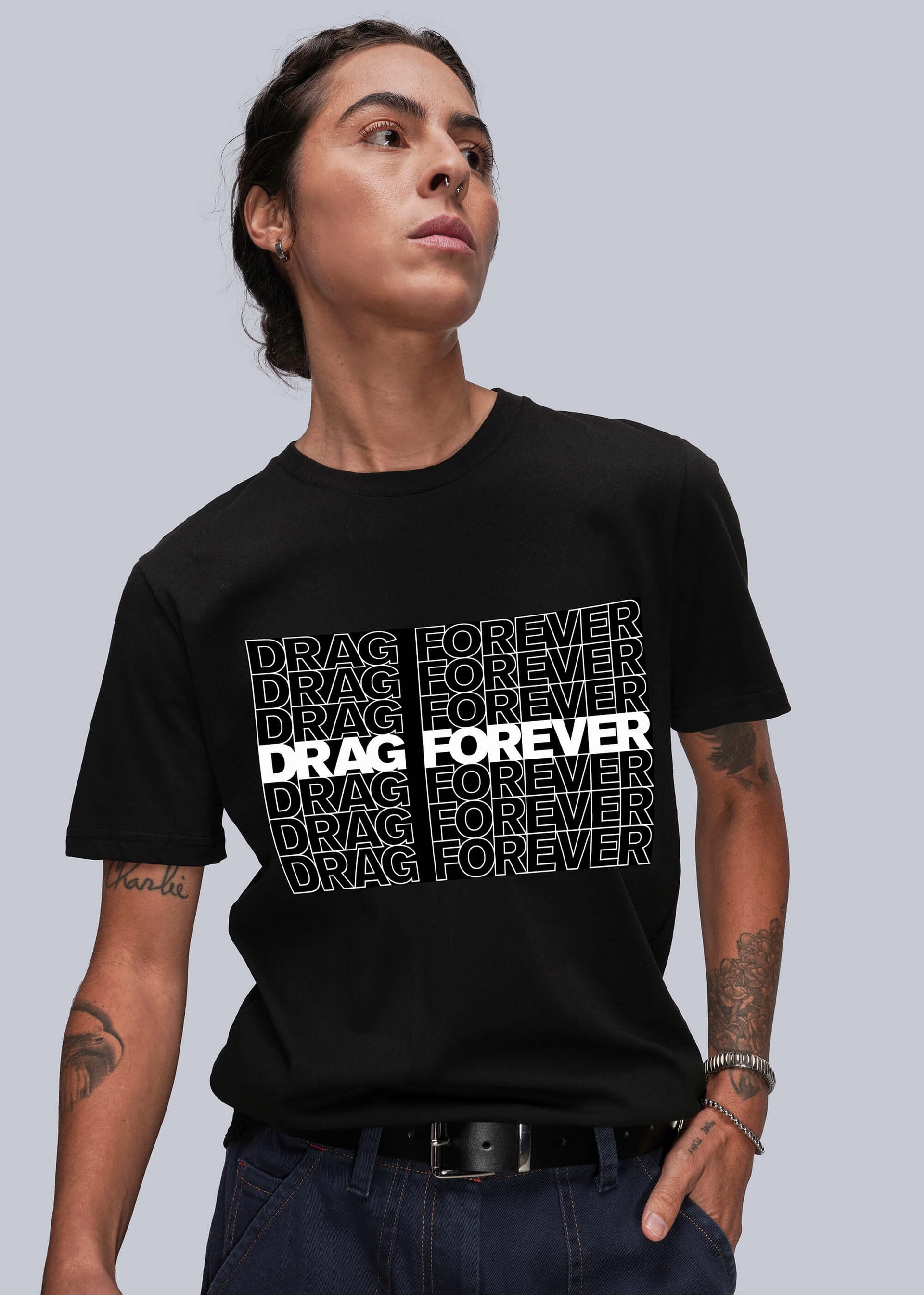 Person wearing a black t-shirt with 'DRAG FOREVER' text on a gray background