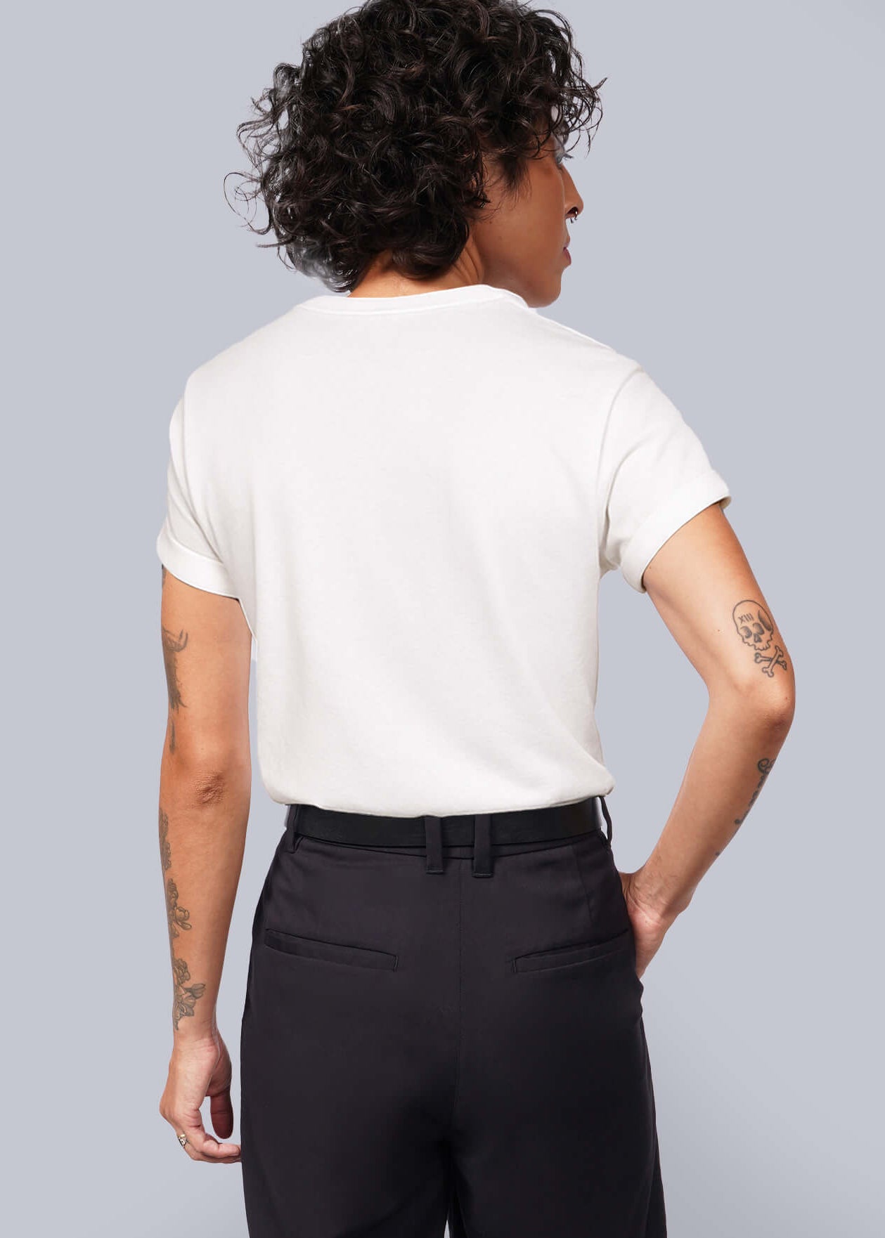 S=Person wearing a white t-shirt and black shorts against a plain background