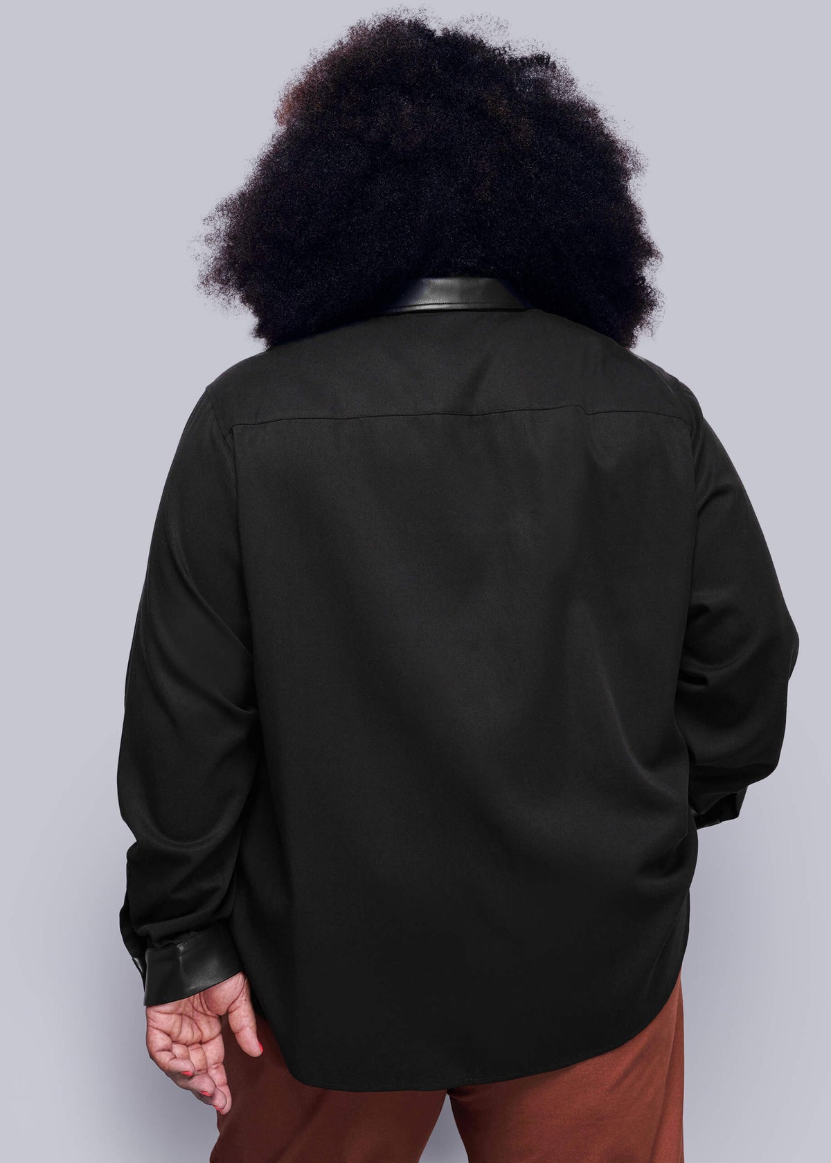 1X=Back view of person wearing a black button up shirt with vegan leather collar on a plain background