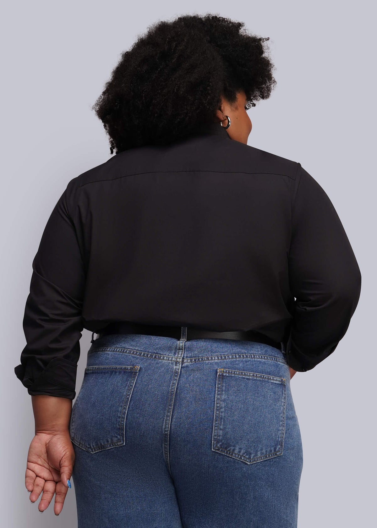 1X=A person shown from the back wearing a black long-sleeve button-up shirt and blue jeans against a light gray studio background.