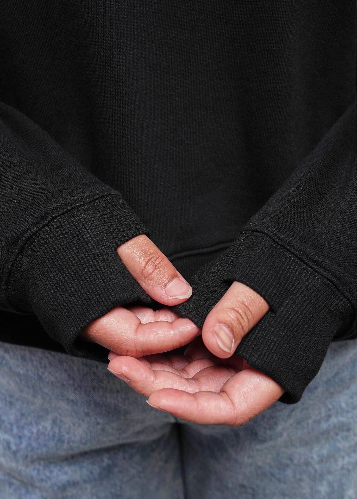 S=Close up of sweatshirt thumb holes