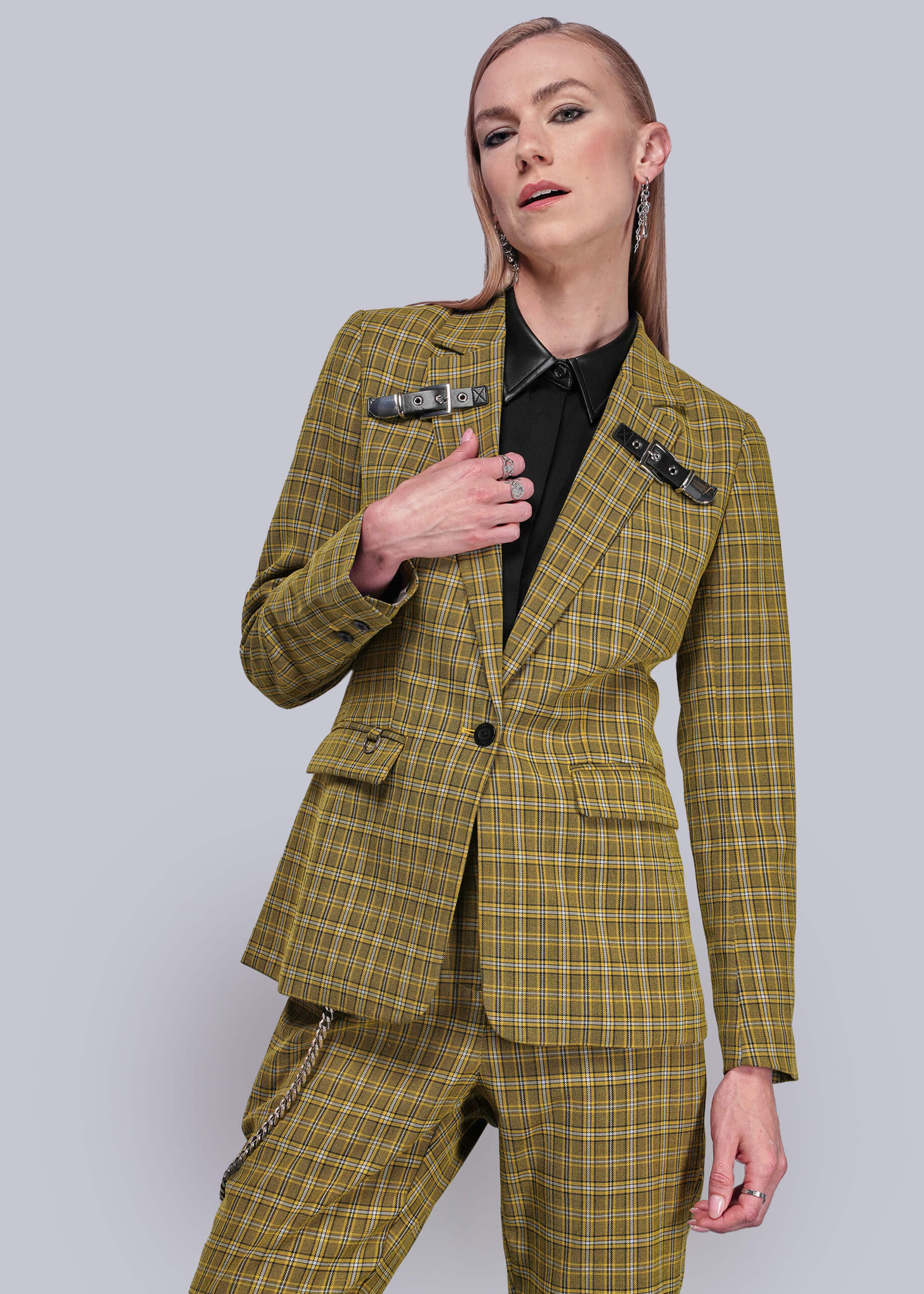 S=Person wearing a yellow plaid suit against a plain background