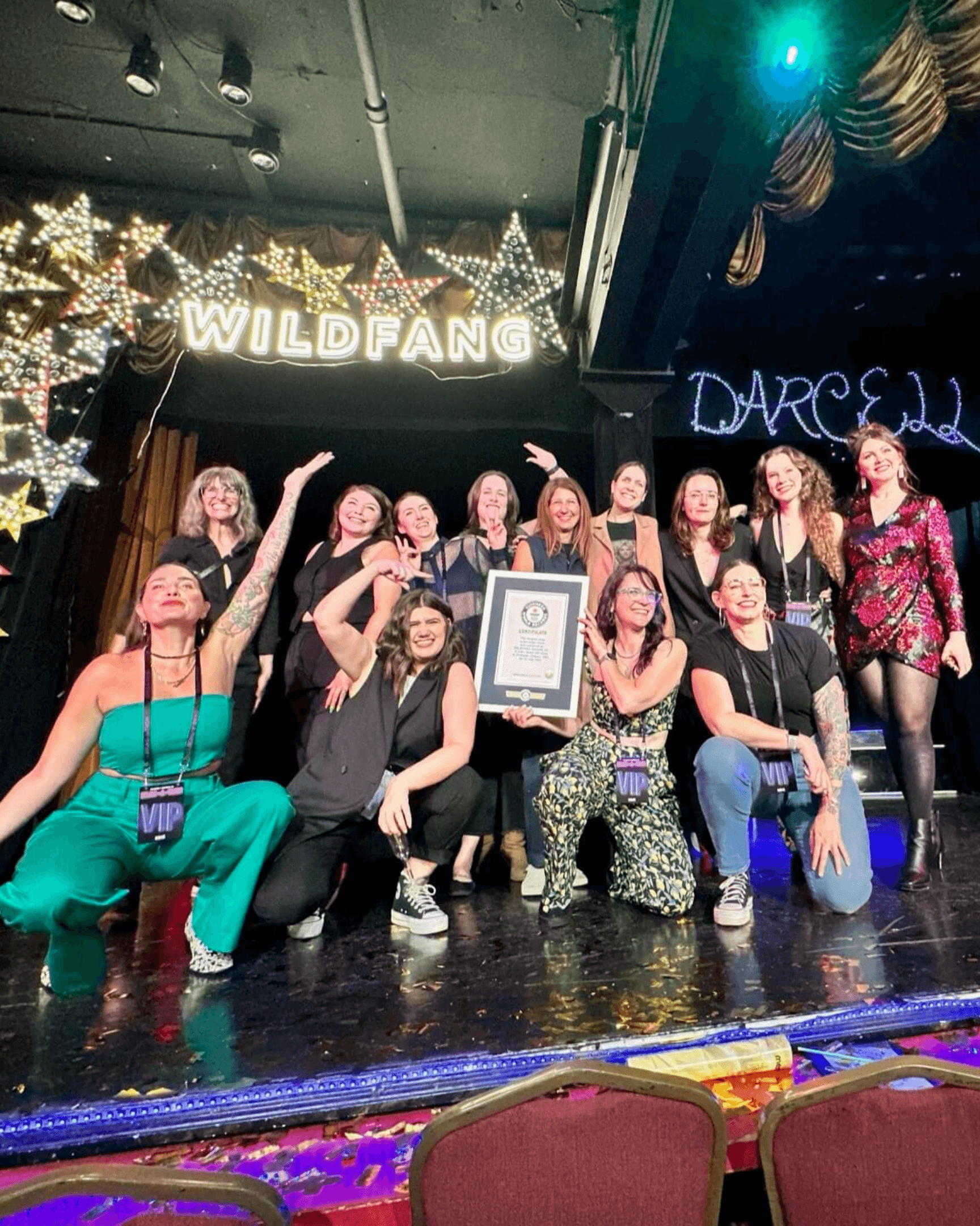 Group photo of event team on stage at Darcelle's in Portland with Guinness World Records Certificate.