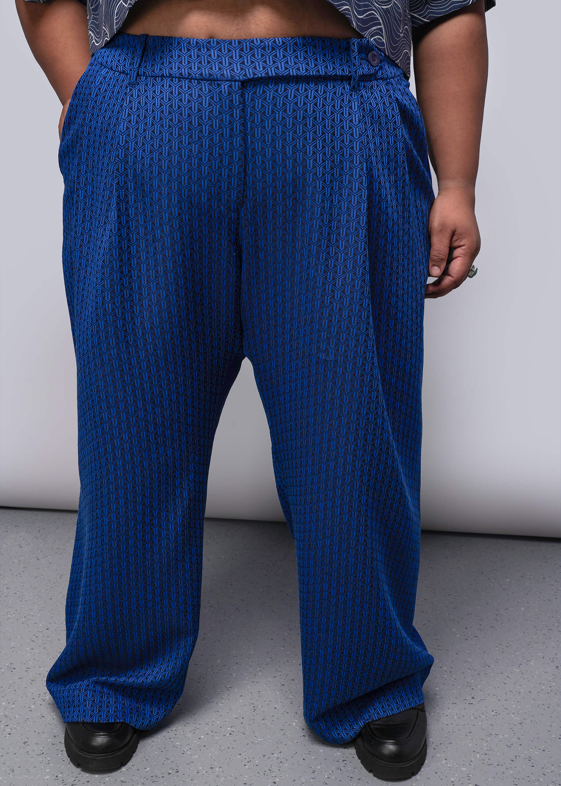 1X=Person wearing blue textured pants on a plain background
