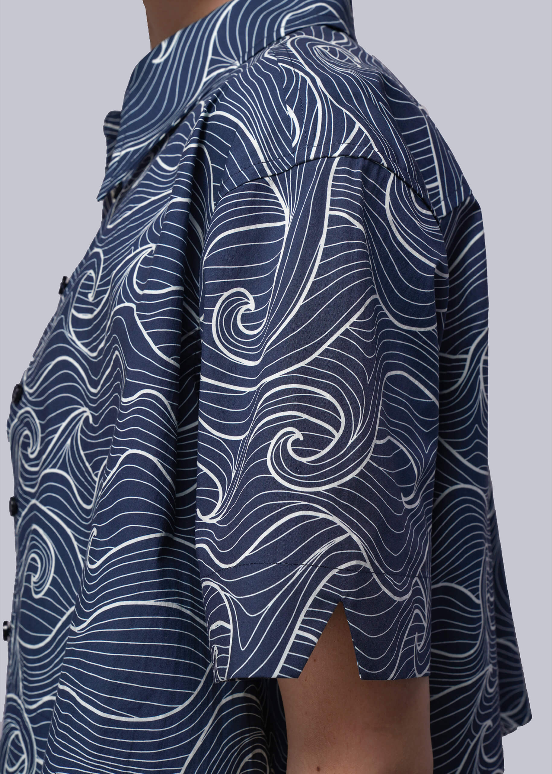 S=Blue patterned shirt with white swirls on a plain background