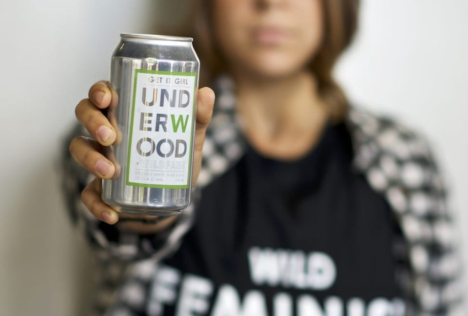 Person holding canned beverage with leabel that reads "Get it Girl" and "Underwood"