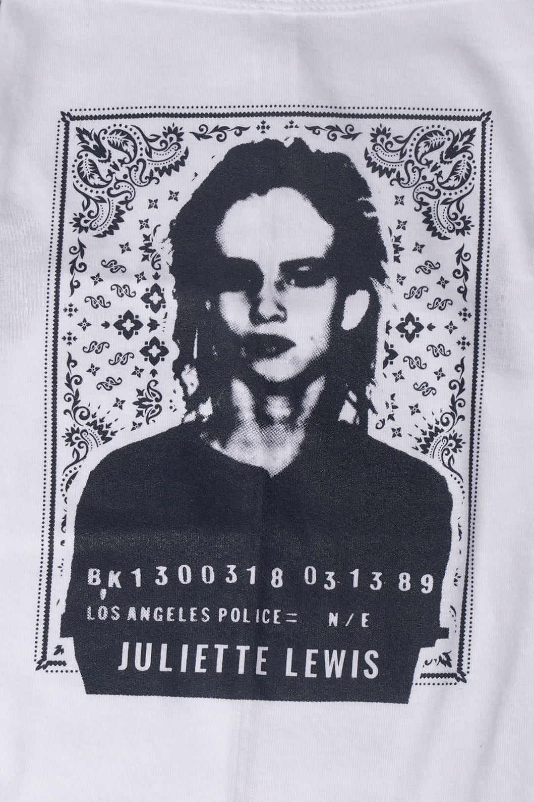 Close up of graphic design on white dog tee laying on a gray surface