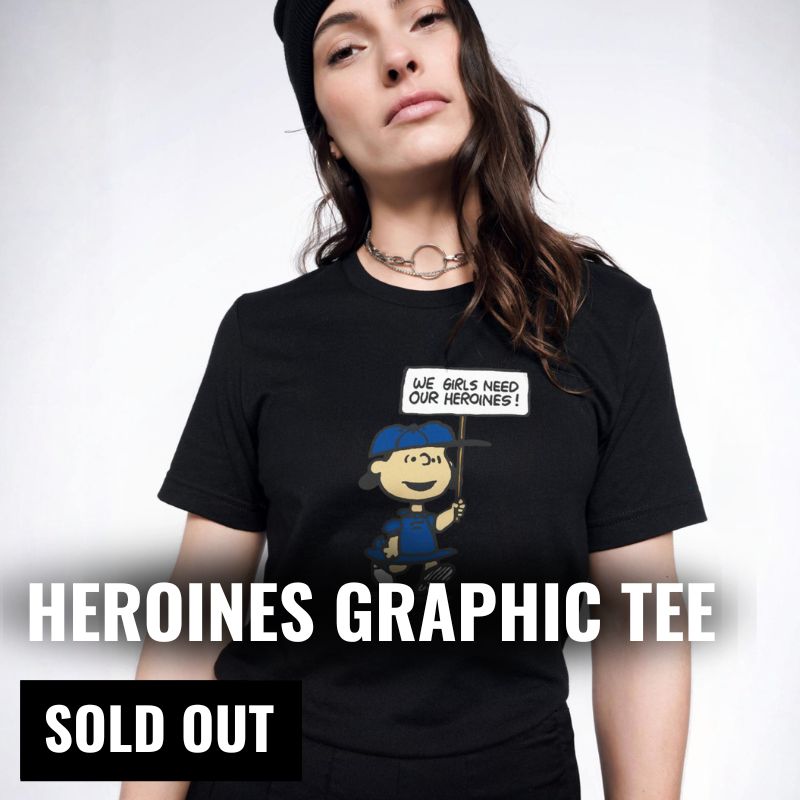 Person wearing The Peanuts x Wildfang Heroines t shirt with text overlay that reads "Heroines Graphic Tee Sold out"