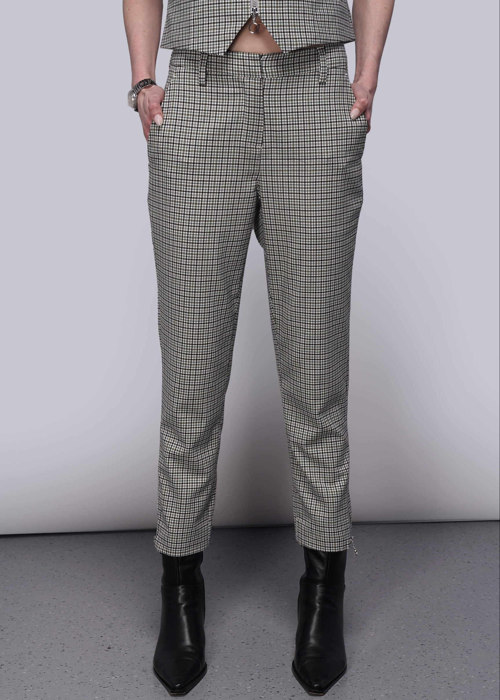 S=Person wearing plaid pants and black boots on a plain background
