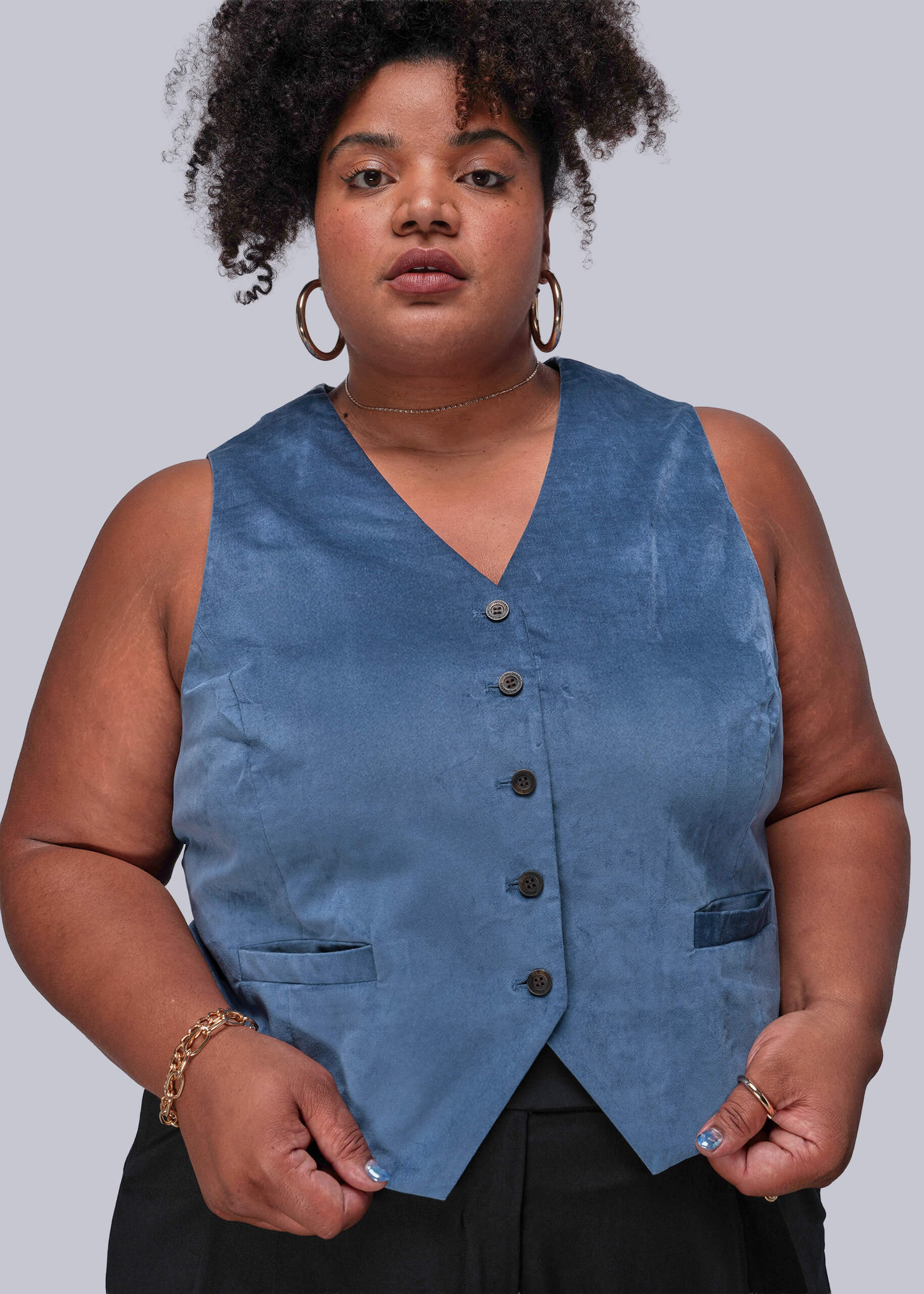 1X=Person wearing a blue vest against a plain background