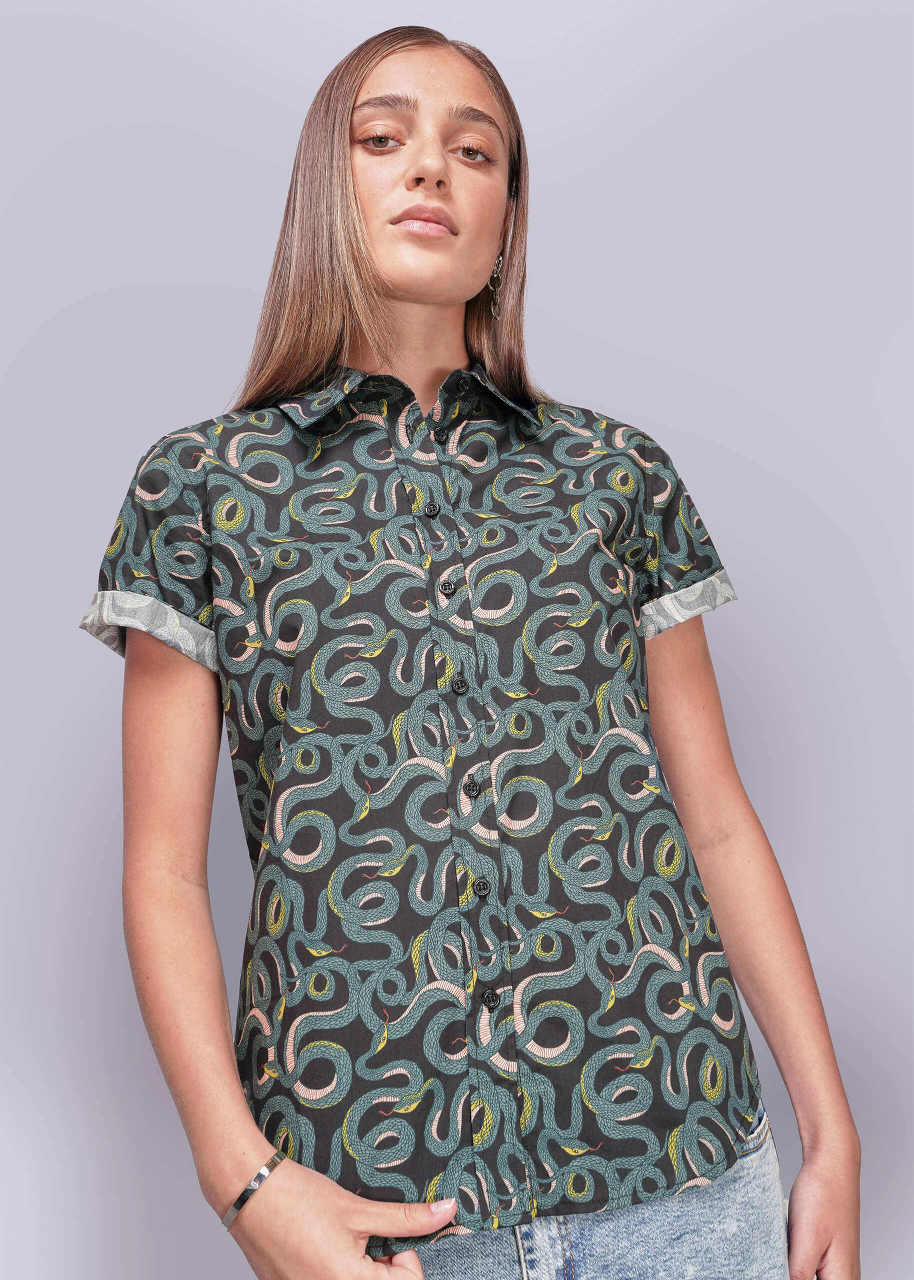 Person wearing a patterned shirt with a plain background