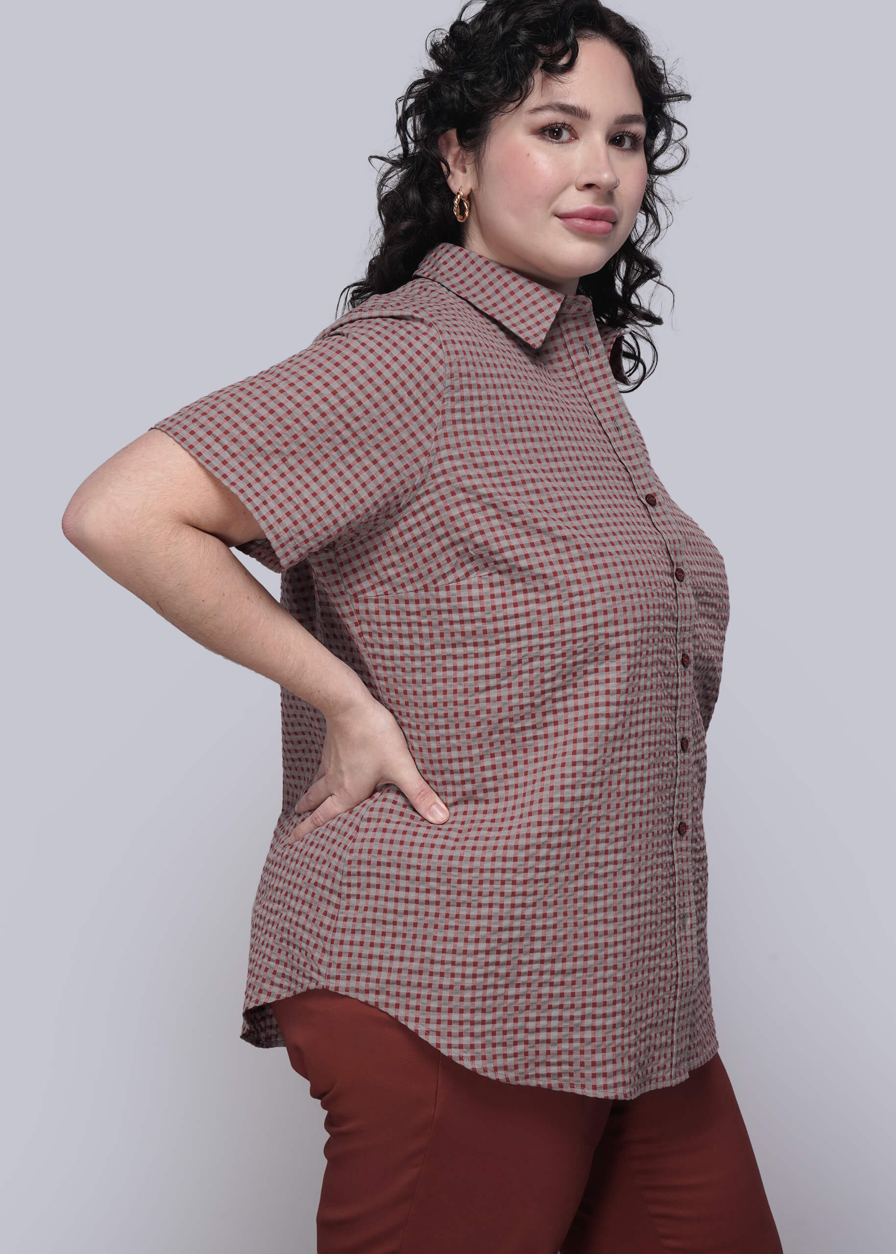 1X=Person wearing a red checkered shirt and red pants against a white background