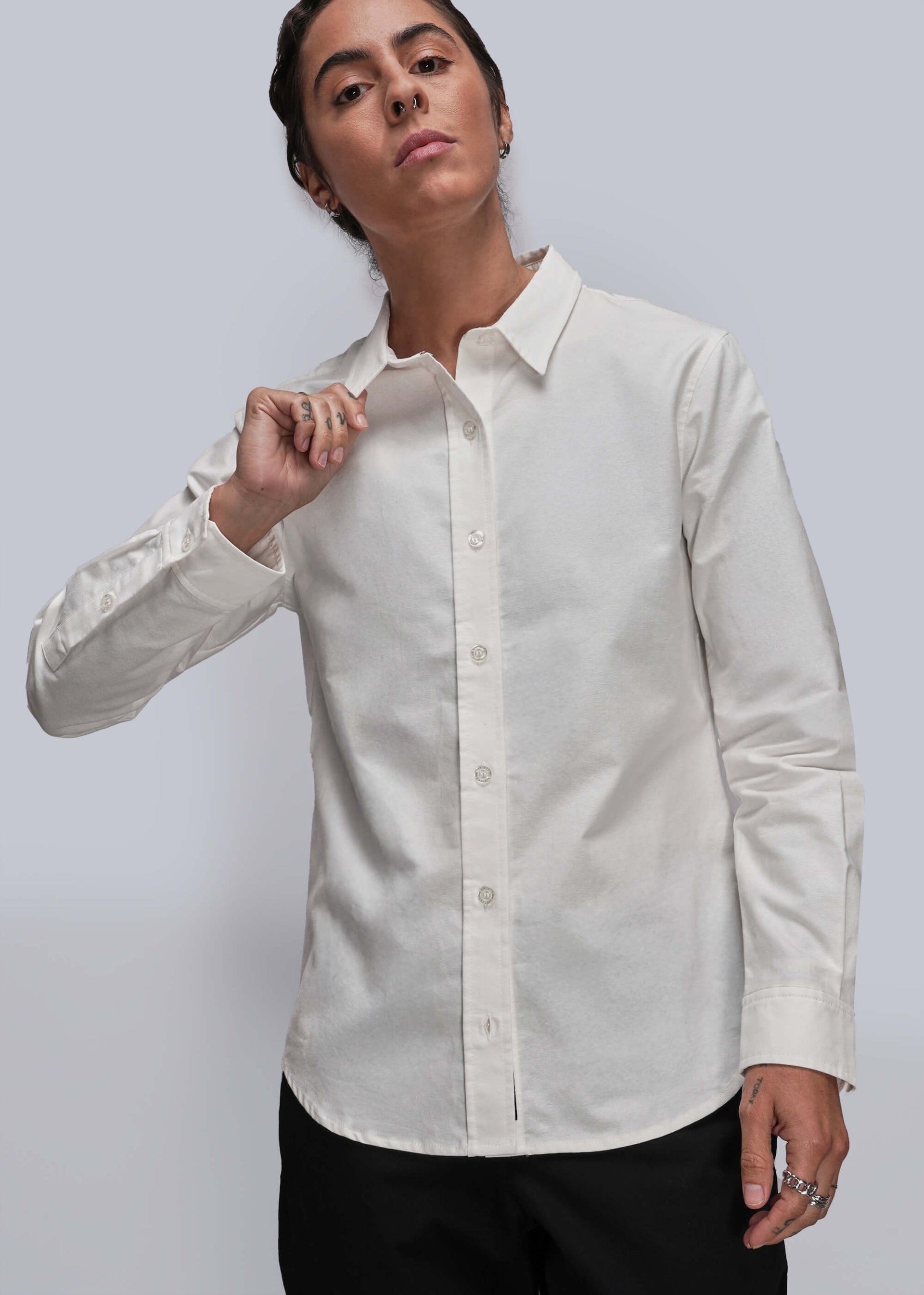 S=Person wearing a white dress shirt with a gray background