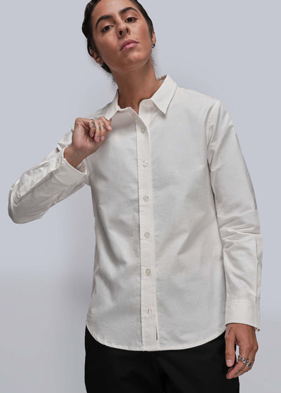 S=Person wearing a white dress shirt with a gray background