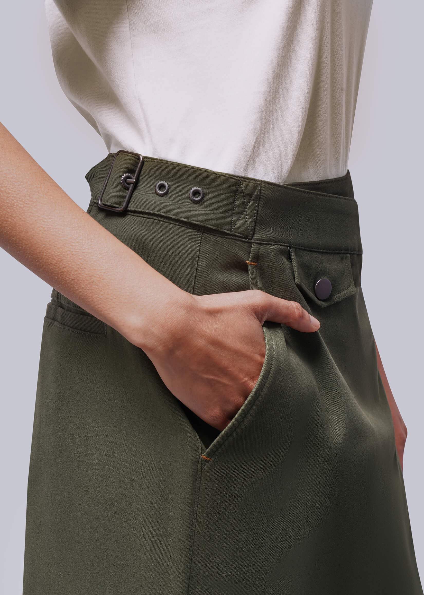 S=Close up of side of green skirt showing adjustable waist buckle