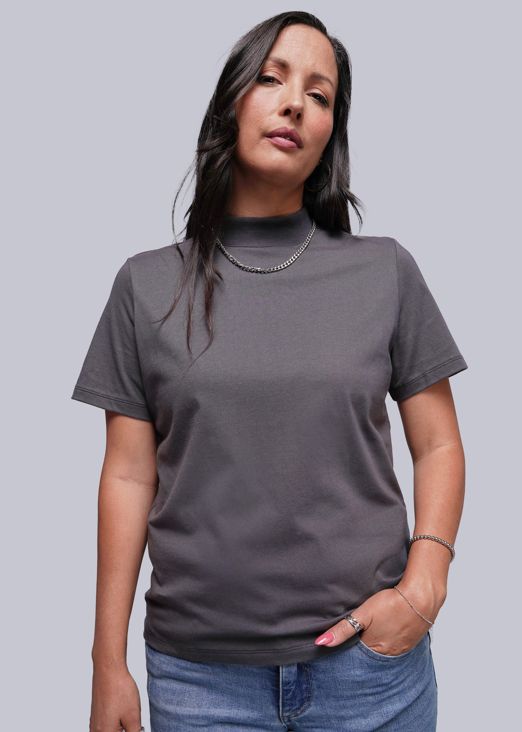 Woman wearing a gray t-shirt against a plain background