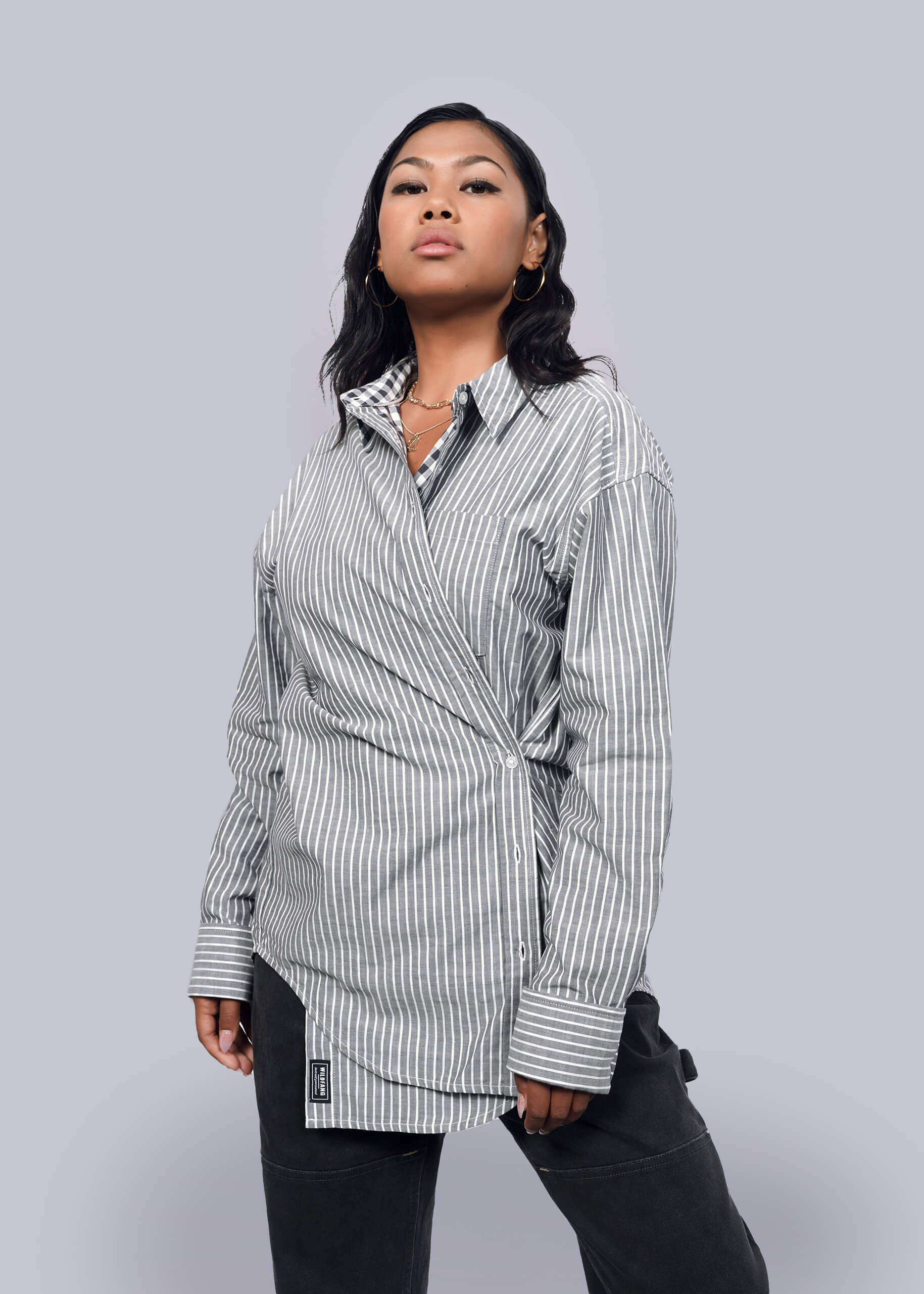  Model wearing The Essential Gingham Long Sleeve Oversized Convertible Button Up in Stripe Navy
