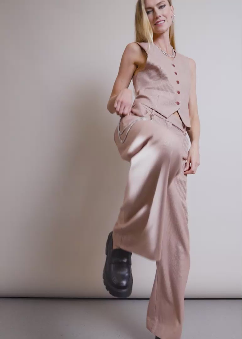 A model wearing The Empower Houndstooth Wide Leg Trouser and Vest shows the fit and features of the product including pockets and stretch