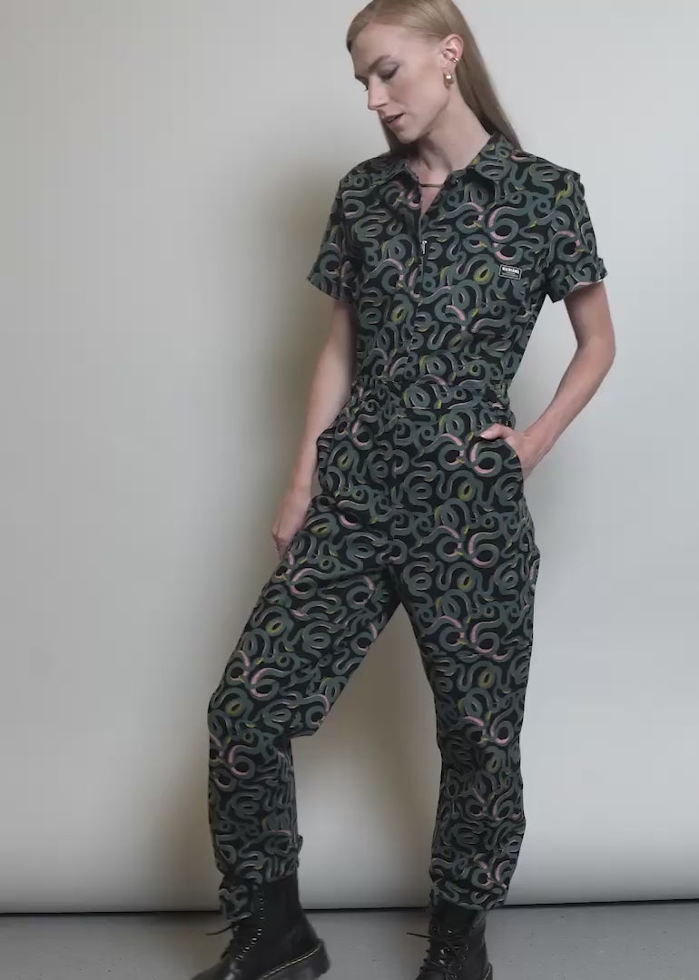 Video shows the High Waisted Short Sleeve Coverall on two models of different sizes. Shows on body and each unique feature of the product including adjustable tab waistband, stretch waistband, lots of real pockets at side, back and front, and soft stretch cotton material