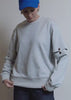 Model shows off the fit and features of the Debbie Harry x Wildfang Convertible Sweatshirt in grey.