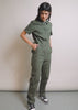 Model shows the fit and features of The Essential Denim High Waisted Cargo Coverall in Spruce green